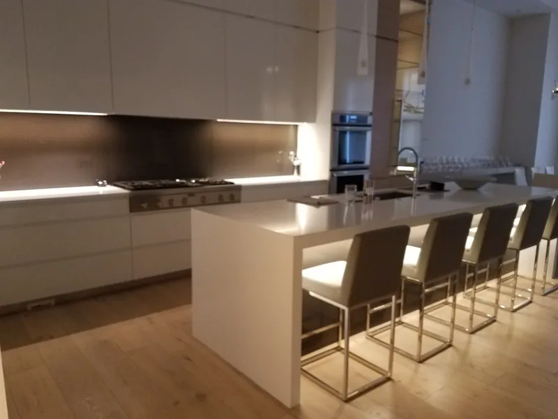 Contemporary custom kitchen with a waterfall island and integrated lighting wired by Northwest Wattage