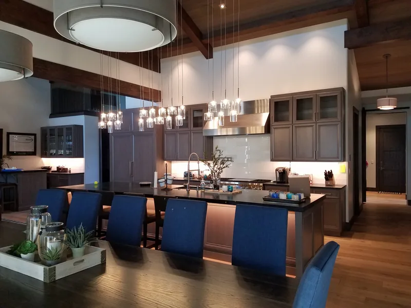 Custom kitchen with pendant lights and exposed timber beams wired by Northwest Wattage