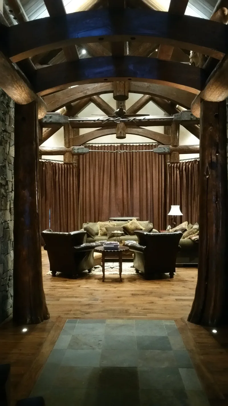 Great room with an arched barrel timber ceiling lit by recessed lighting installed by Northwest Wattage