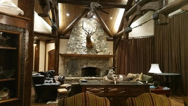 Lodge great room with a stone fireplace and layered lighting wired by Northwest Wattage in Coeur d'Alene