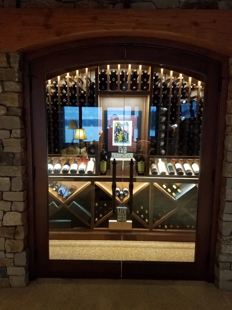 Arched wine cellar entry with display lighting installed by Northwest Wattage